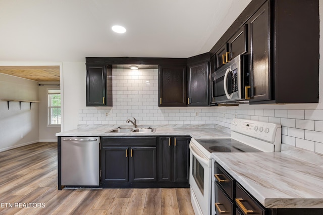 210 Conifer Rd, Winfield, TN 37892 - kitchen featuring stainless steel appliances, light wood finished floors, backsplash, light stone countertops, and recessed lighting