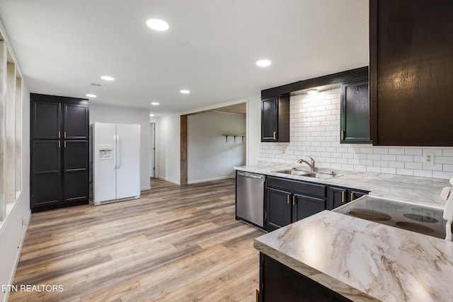 210 Conifer Rd, Winfield, TN 37892 - kitchen with white refrigerator with ice dispenser, stainless steel dishwasher, tasteful backsplash, light wood finished floors, and recessed lighting