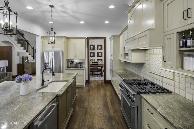 11211 Matthews Cove Ln, Knoxville, TN 37934 - kitchen featuring stainless steel appliances, cream cabinetry, light stone countertops, hanging light fixtures, and ornamental molding
