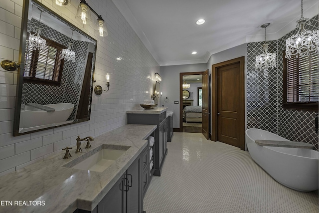 11211 Matthews Cove Ln, Knoxville, TN 37934 - full bathroom with tile walls, two vanities, a chandelier, crown molding, and a freestanding bath