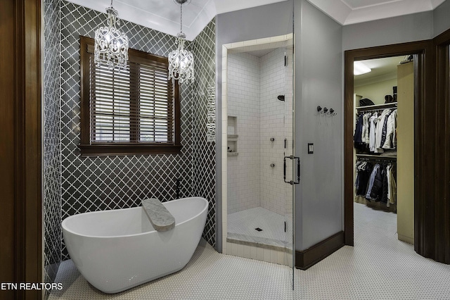 11211 Matthews Cove Ln, Knoxville, TN 37934 - bathroom with a stall shower, a soaking tub, a walk in closet, a chandelier, and tile patterned floors