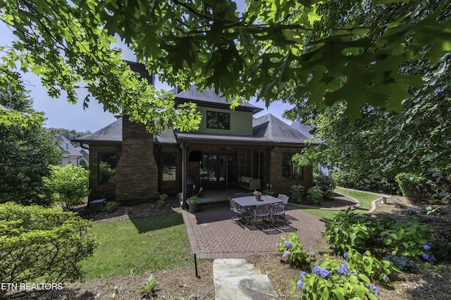 11211 Matthews Cove Ln, Knoxville, TN 37934 - rear view of property with brick siding, a patio, a shingled roof, and a yard