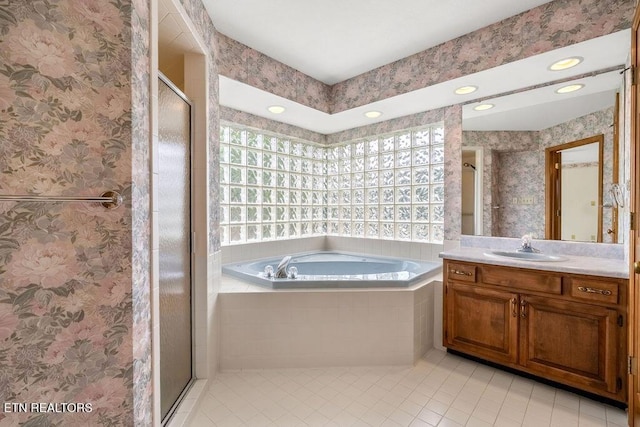 136 Oostagala Dr, Loudon, TN 37774 - full bath with tile patterned floors, vanity, a bath, a shower stall, and wallpapered walls