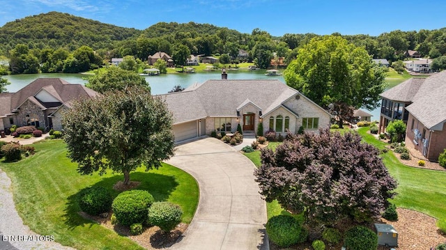 136 Oostagala Dr, Loudon, TN 37774 - view of front of home featuring a water view, a garage, concrete driveway, and stone siding