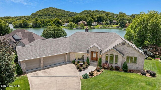 136 Oostagala Dr, Loudon, TN 37774 - view of front facade featuring brick siding, driveway, a front yard, and a water view