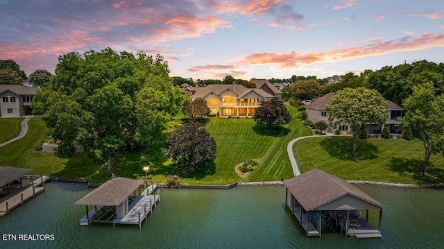136 Oostagala Dr, Loudon, TN 37774 - aerial view at dusk of a water view and view of wooded area
