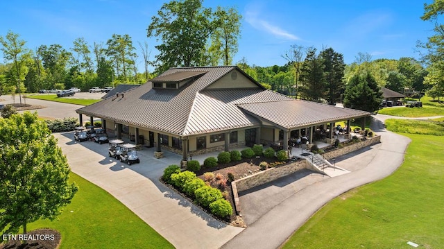 136 Oostagala Dr, Loudon, TN 37774 - view of front facade with stone siding, a metal roof, a front lawn, a standing seam roof, and a porch