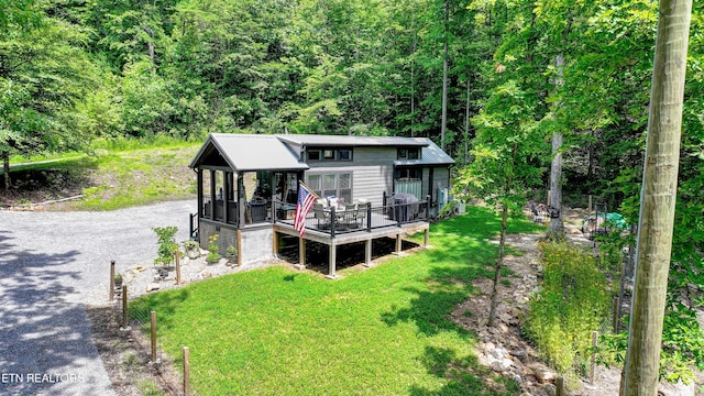 1429 Alpine Dr, Sevierville, TN 37876 - view of front of house with a deck, a front lawn, a view of trees, and driveway