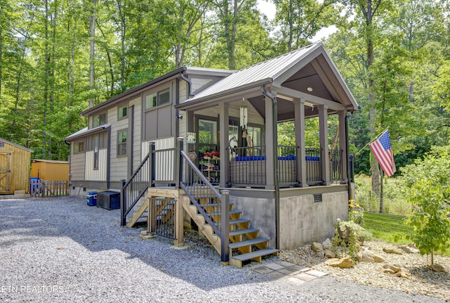 1429 Alpine Dr, Sevierville, TN 37876 - view of front of home featuring a storage shed, a porch, and a metal roof