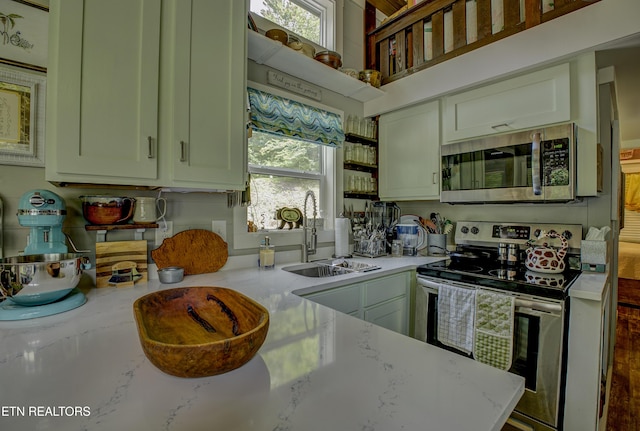 1429 Alpine Dr, Sevierville, TN 37876 - kitchen with stainless steel appliances, plenty of natural light, light stone counters, and open shelves