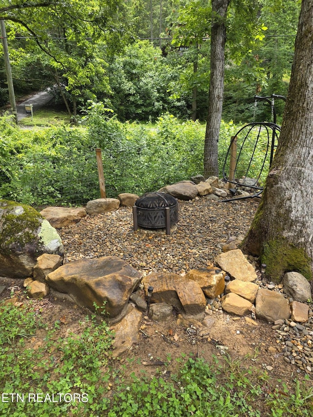 1429 Alpine Dr, Sevierville, TN 37876 - view of yard featuring an outdoor fire pit and a view of trees