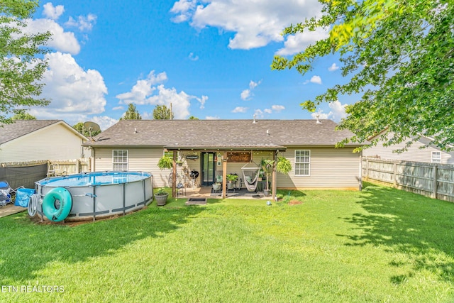 7527 Wheatmeadow Rd, Corryton, TN 37721 - back of property featuring a fenced backyard, a patio, and a shingled roof