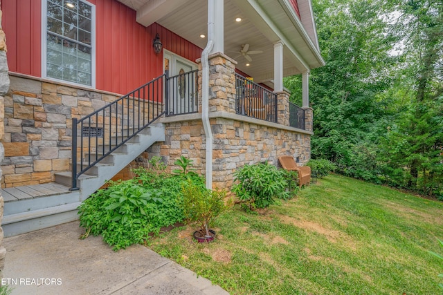 135 Chanusi Way, Loudon, TN 37774 - property entrance with stone siding, a lawn, board and batten siding, and a ceiling fan