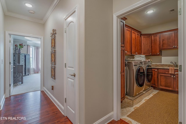 135 Chanusi Way, Loudon, TN 37774 - laundry area featuring washing machine and dryer, cabinet space, crown molding, and wood finished floors