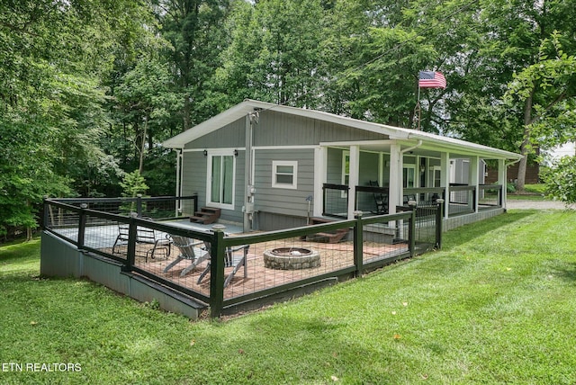 502 Midnight Dr, Byrdstown, TN 38549 - back of house with a yard, a fire pit, and a deck