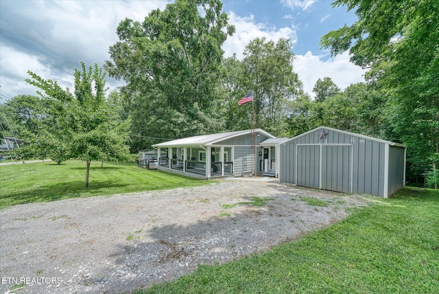 502 Midnight Dr, Byrdstown, TN 38549 - view of front of property with a front lawn, covered porch, a detached garage, and driveway