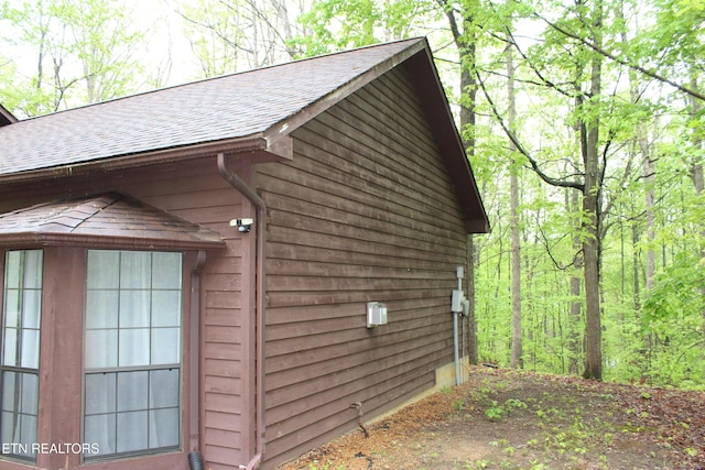 108 Laurel Dr, Jamestown, TN 38556 - view of side of home featuring a shingled roof and a wooded view