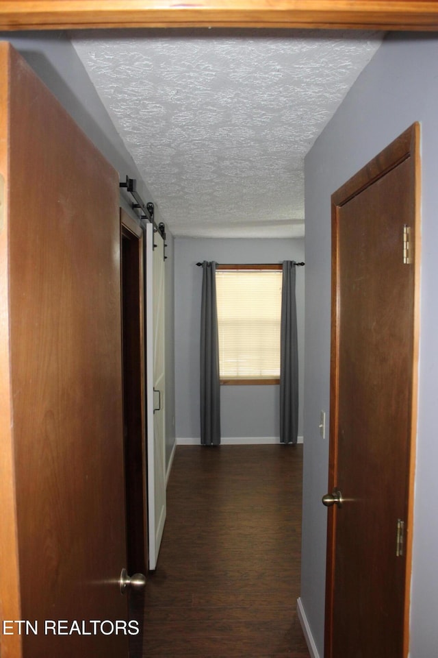 108 Laurel Dr, Jamestown, TN 38556 - corridor with dark wood finished floors, a textured ceiling, and a barn door
