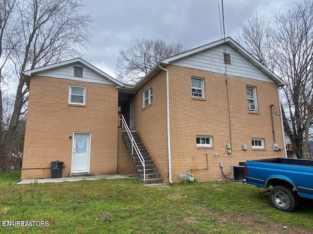 722 Sewanee St, Harriman, TN 37748 - rear view of property featuring brick siding, a lawn, and stairway