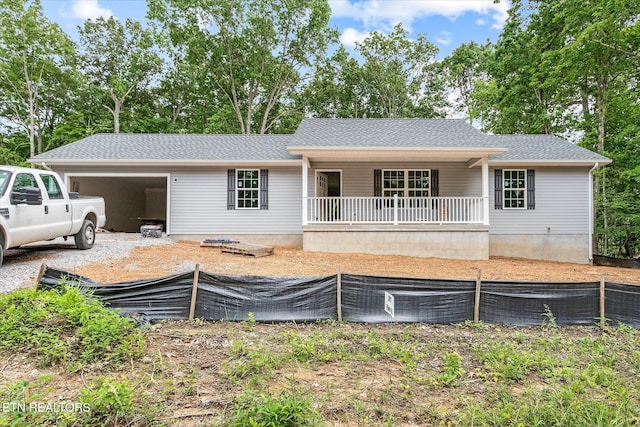 2017 Piute Rd, Crossville, TN 38572 - ranch-style home featuring a porch, an attached garage, and a shingled roof
