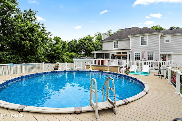 7110 Royal Springs Blvd, Knoxville, TN 37918 - view of pool with a sunroom, a wooden deck, and a storage unit