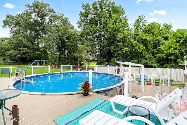 7110 Royal Springs Blvd, Knoxville, TN 37918 - view of swimming pool featuring a wooden deck and view of wooded area