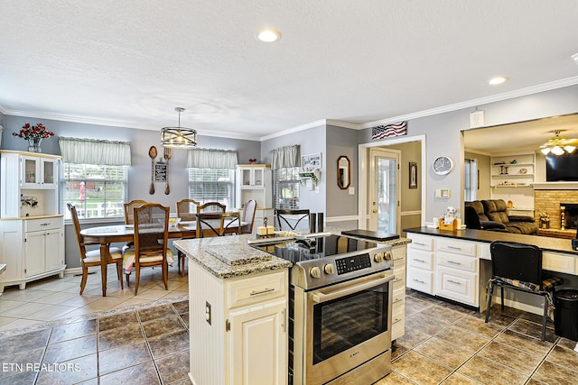 7110 Royal Springs Blvd, Knoxville, TN 37918 - kitchen with stainless steel range with electric stovetop, open floor plan, a textured ceiling, crown molding, and a kitchen island