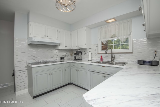 506 Blockhouse Valley Rd, Clinton, TN 37716 - kitchen featuring under cabinet range hood, decorative backsplash, a chandelier, black electric stovetop, and white cabinetry