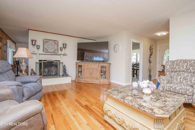 506 Blockhouse Valley Rd, Clinton, TN 37716 - living room featuring wood finished floors and a brick fireplace
