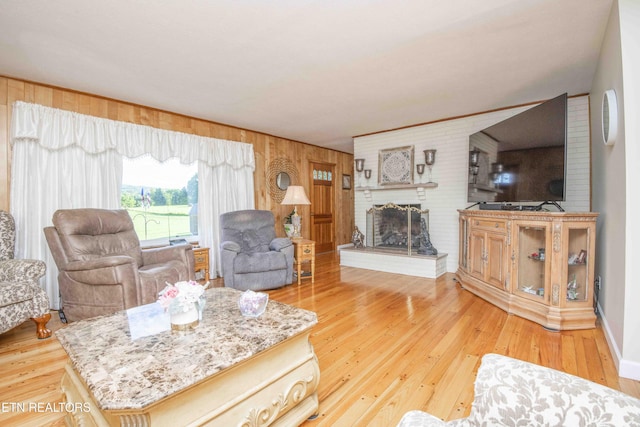 506 Blockhouse Valley Rd, Clinton, TN 37716 - living area with wooden walls, light wood-type flooring, and a brick fireplace