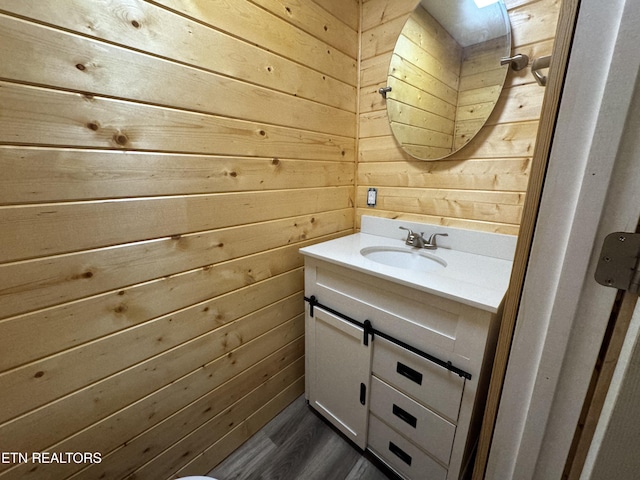 109 Henry Mayfield Rd, Tellico Plains, TN 37385 - bathroom featuring wooden walls, vanity, and wood finished floors