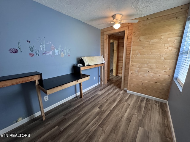 109 Henry Mayfield Rd, Tellico Plains, TN 37385 - dining area featuring a textured ceiling, wood finished floors, wood walls, and ceiling fan