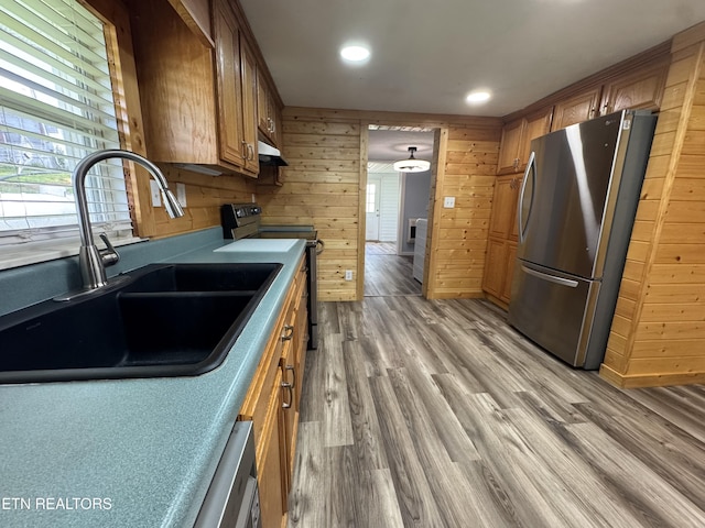 109 Henry Mayfield Rd, Tellico Plains, TN 37385 - kitchen featuring appliances with stainless steel finishes, brown cabinets, exhaust hood, recessed lighting, and light wood finished floors
