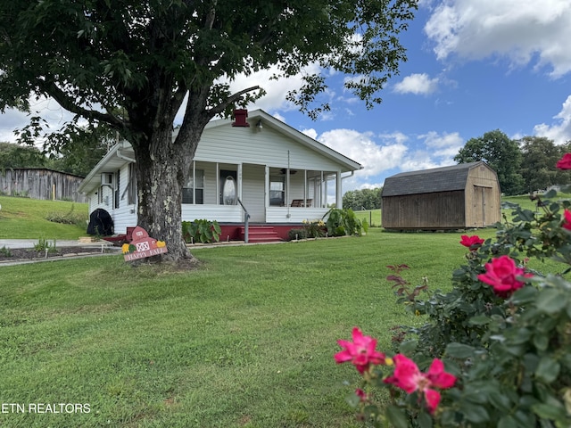 109 Henry Mayfield Rd, Tellico Plains, TN 37385 - view of front of house featuring a storage unit, covered porch, and a front lawn