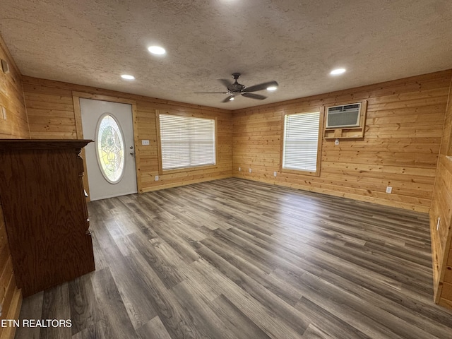 109 Henry Mayfield Rd, Tellico Plains, TN 37385 - foyer with a wall unit AC, a ceiling fan, wood finished floors, wooden walls, and a textured ceiling