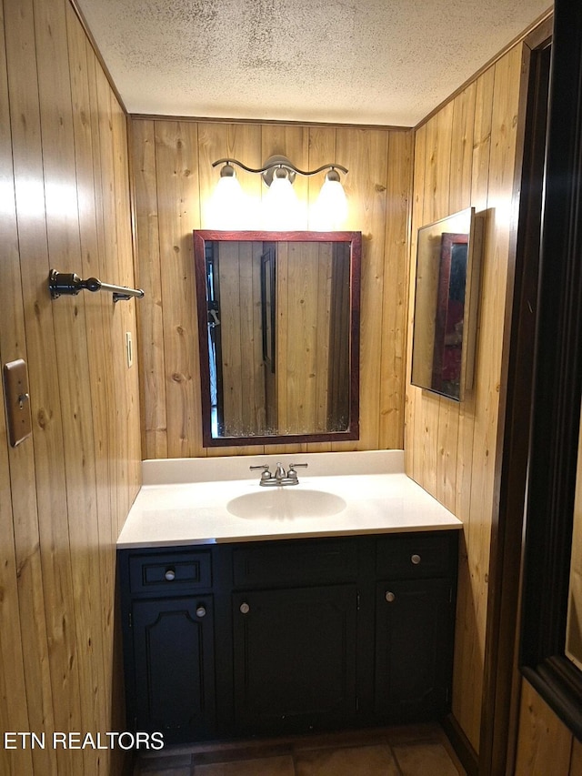 1081 Cove Rd Unit 623, Sevierville, TN 37876 - bathroom with wooden walls, vanity, and a textured ceiling