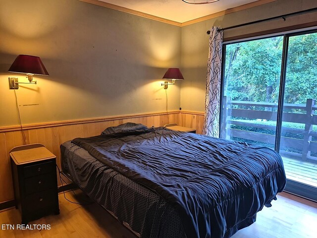 1081 Cove Rd Unit 623, Sevierville, TN 37876 - bedroom featuring wainscoting, wood finished floors, crown molding, and wooden walls