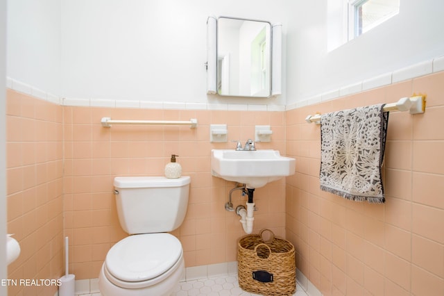 7908 Collier Rd, Powell, TN 37849 - half bath with tile walls, a wainscoted wall, and tile patterned floors