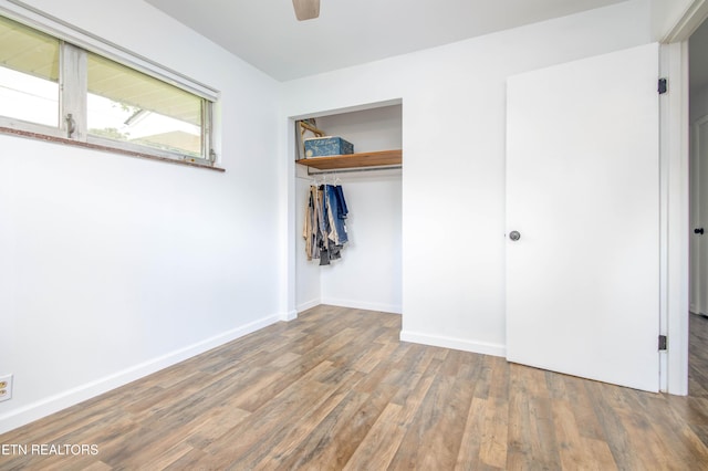 7908 Collier Rd, Powell, TN 37849 - unfurnished bedroom with wood finished floors, a closet, and ceiling fan
