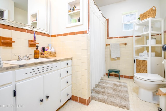 7908 Collier Rd, Powell, TN 37849 - full bath with tile walls, vanity, wainscoting, and a shower with shower curtain