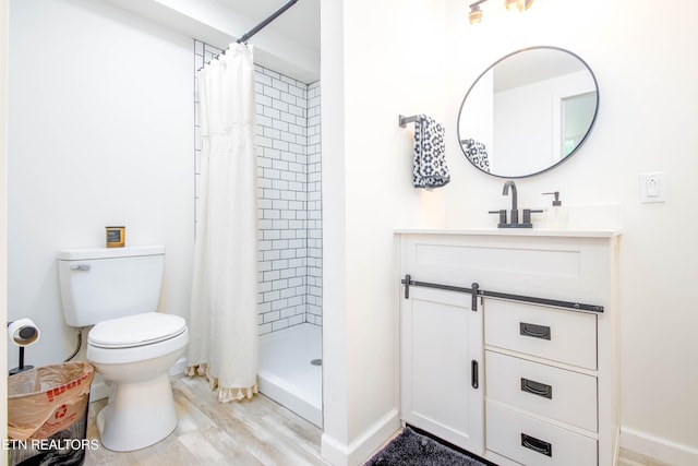7908 Collier Rd, Powell, TN 37849 - full bath featuring vanity, tiled shower, and wood finished floors