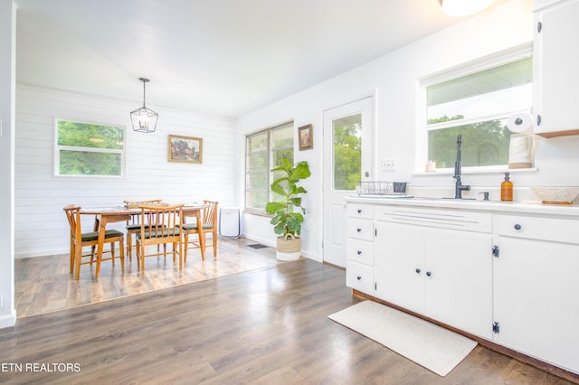 7908 Collier Rd, Powell, TN 37849 - dining room featuring healthy amount of natural light, wood finished floors, and wood walls