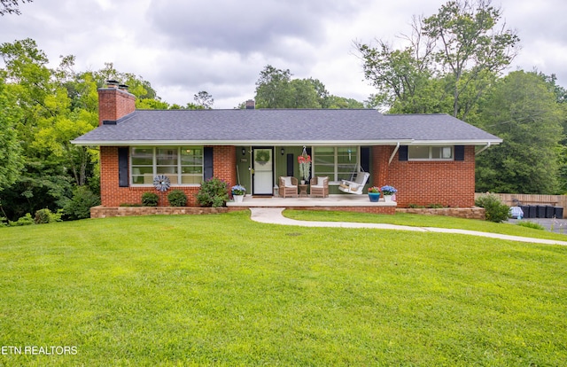 7908 Collier Rd, Powell, TN 37849 - single story home with a chimney, brick siding, and a front yard