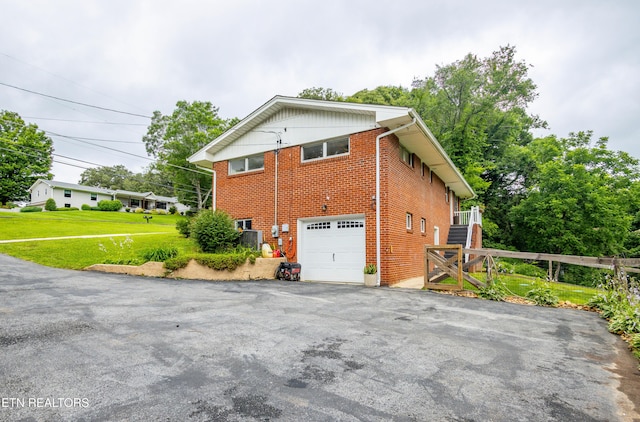 7908 Collier Rd, Powell, TN 37849 - view of side of property with brick siding, driveway, and an attached garage
