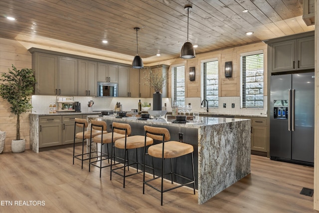 1646 Bear Valley Rd, Sevierville, TN 37876 - kitchen with stainless steel appliances, wooden ceiling, a center island, light wood finished floors, and tasteful backsplash