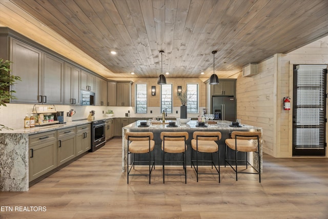 1646 Bear Valley Rd, Sevierville, TN 37876 - kitchen with high quality appliances, wooden ceiling, an island with sink, light stone countertops, and a breakfast bar