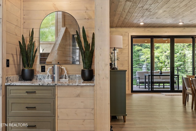 1646 Bear Valley Rd, Sevierville, TN 37876 - kitchen with wooden ceiling, plenty of natural light, light stone counters, light wood-style flooring, and wooden walls