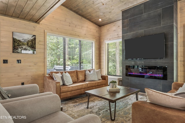 1646 Bear Valley Rd, Sevierville, TN 37876 - living area with wood ceiling, wood walls, vaulted ceiling, and a glass covered fireplace