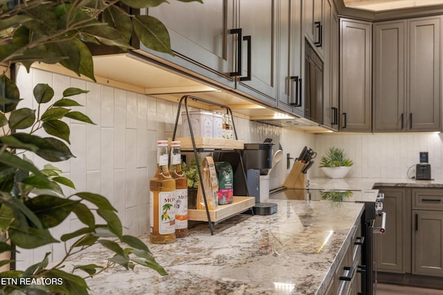 1646 Bear Valley Rd, Sevierville, TN 37876 - kitchen featuring stainless steel electric range, light stone countertops, and wood walls