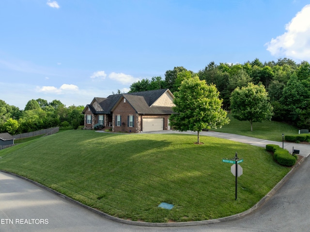 5484 Shadow Branch Ln, Corryton, TN 37721 - view of front of house with asphalt driveway, a front yard, brick siding, and a garage
